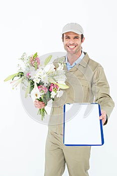 Delivery man with bouquet giving clipboard for signature
