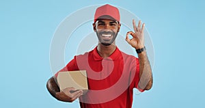 Delivery man, box and okay hands for success, product excellence and courier services in studio. Happy face of supply