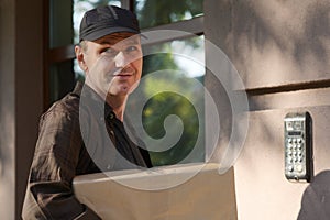 Delivery man with a box outdoors