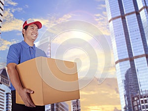 Delivery man and card box delivering in city building