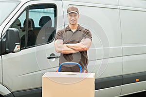 Delivery Man With Cardboard Boxes On Trolley