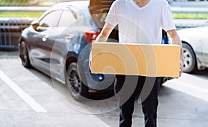 Delivery man carrying cardboard box for sending to receiver customer by transportation