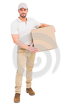 Delivery man carrying cardboard box