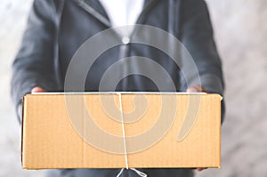 Delivery man carrying a parcel box