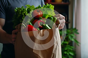 Delivery man courier holding a bag with vegetable and food