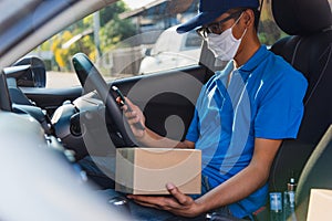 Delivery man courier holding deliveries out boxes and using mobile phone contact the customer