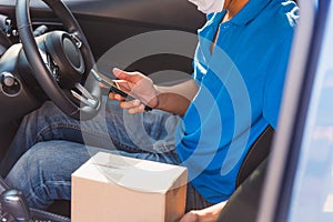 Delivery man courier holding deliveries out boxes and using mobile phone contact the customer
