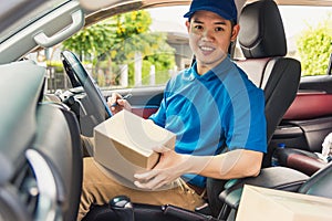 Delivery man courier in uniform hold documents clipboard checking list parcel post boxes inside a car