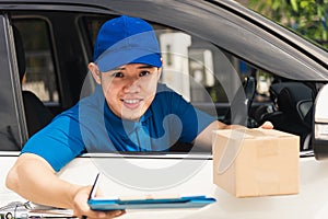 Delivery man courier wear uniform in the car hold documents clipboard hand over to customer to signing