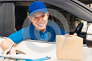 Delivery man courier wear uniform in the car hold documents clipboard hand over to customer to signing