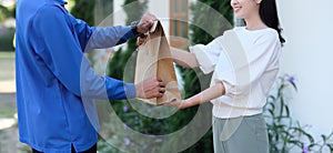 delivery man Deliver a paper bag package to the beautiful woman at the front of the house according to the order.