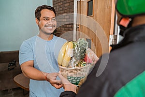 Delivery man delivering fruit parcel photo