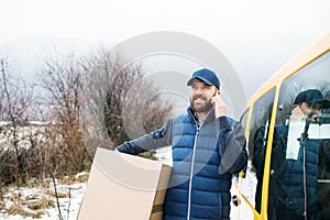 Delivery man delivering parcel box to recipient.