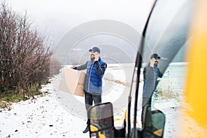 Delivery man delivering parcel box to recipient.