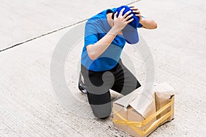 Delivery man he emotional courier hold damaged cardboard box is broken