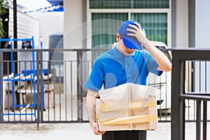 Delivery man he emotional courier hold damaged cardboard box is broken