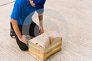 Delivery man he emotional courier hold damaged cardboard box is broken