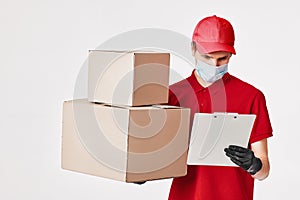 Delivery man employee in red cap face mask, empty cardboard box