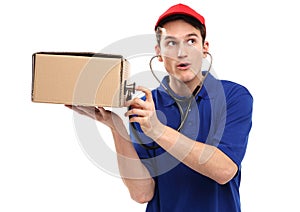 Delivery man examining box with stethoscope