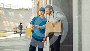 Delivery Man Gives Postal Package to a Business Customer, Who Signs Electronic Signature POD Devic