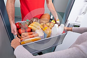 Delivery Man Giving Grocery Box To Woman