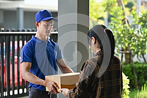 Delivery man giving postal package to customer at doorway. Delivery service, post and shipping concept