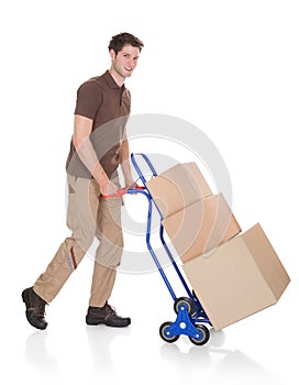 Delivery man with hand truck and boxes