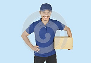 Delivery man holding box on blue background
