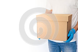 Delivery man holding cardboard boxes in blue rubber gloves with copy space. Fast and free Delivery transport . Online