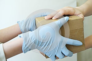 Delivery man holding cardboard boxes in medical rubber gloves. Fast and free Delivery transport . Copy space. Online shopping and