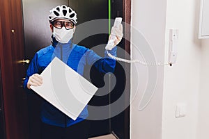 Delivery man holding cardboard boxes in medical rubber gloves and mask. copy space. Fast and free Delivery transport