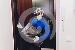 Delivery man holding cardboard boxes in medical rubber gloves and mask. copy space. Fast and free Delivery transport