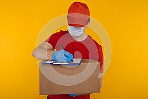 Delivery man holding cardboard boxes in medical rubber gloves and mask. copy space. Fast and free Delivery transport