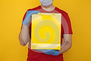 Delivery man holding cardboard boxes in medical rubber gloves and mask. copy space. Fast and free Delivery transport