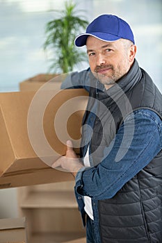 delivery man holding and carrying cardbox