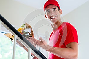 Delivery man holding flower bouquet