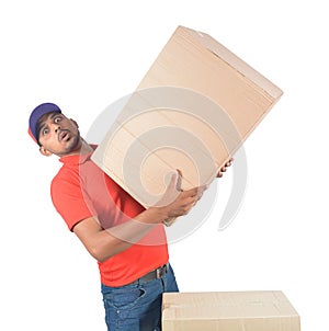 Delivery man holding heavy carton box in uniform