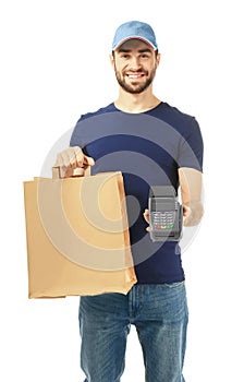 Delivery man holding paper bag with food and payment terminal on white background