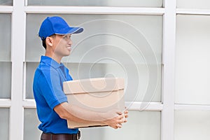 Delivery man holding a parcel box