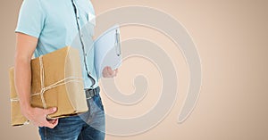Delivery man holding parcel box and clipboard against beige background