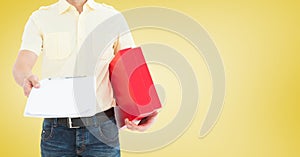 Delivery man holding a parcel and clipboard against yellow background