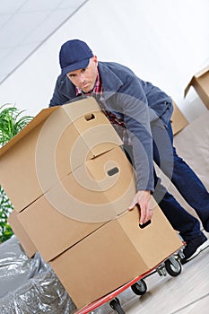 Delivery man with lot cardbox package