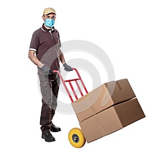 Delivery man with mask for covid-19. handtruck with packages photo