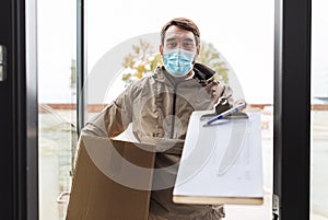 delivery man in mask with parcel box and clipboard