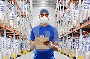 Delivery man in mask or respirator at warehouse photo