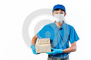Delivery man in medical safety mask holding and carrying a card box