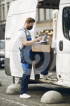 Delivery man with package outdoors