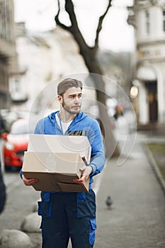 Delivery man with package outdoors