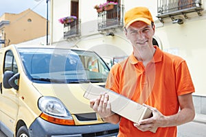 delivery man with package outdoors. Shipping services