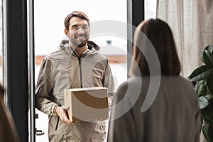 delivery man with parcel box and customer at home